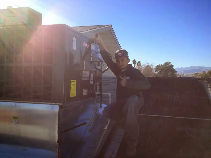 HVAC technician performing Boiler Repair on a rooftop unit in Nevada